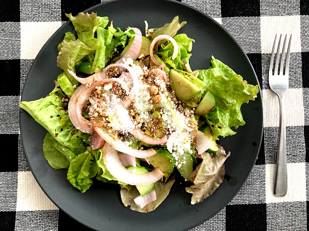 Leafy green salad with goat cheese on a plate